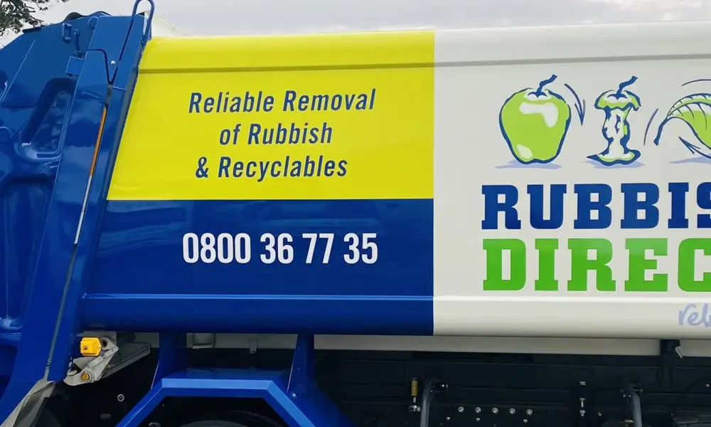 Side View of a Blue and White Rubbish Removal Truck with a Yellow Panel Reading aposreliable Removal of Rubbish Recyclablesapos and the Phone Number 0800 36 77 35
