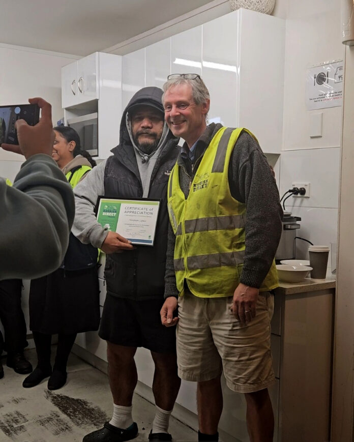 Celebrating incredible years with pepa lepaiojpg | Rubbish Direct Two Men Posing for a Photo in a Bright Kitchen One in a Yellow Highvisibility Vest and Shorts the Other in a Hooded Jacket Holding a Certificate of Appreciation Smiling