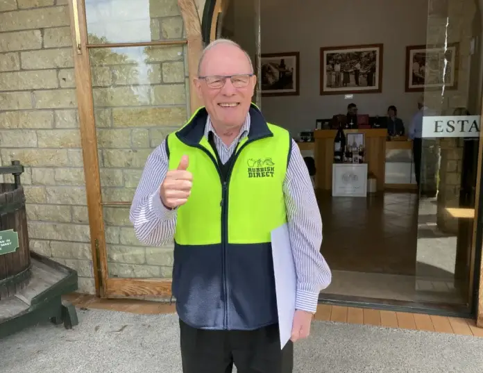 Working alongside david taylorwebp | Rubbish Direct Older Man Wearing a Bright Yellow and Blue High visibility Vest Gives a Thumbs Up Outside a Building Holding a Folder